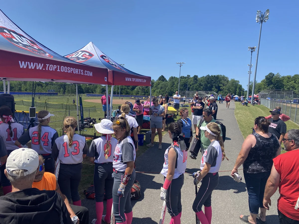 Softball athletes and families visiting the testing tents between games